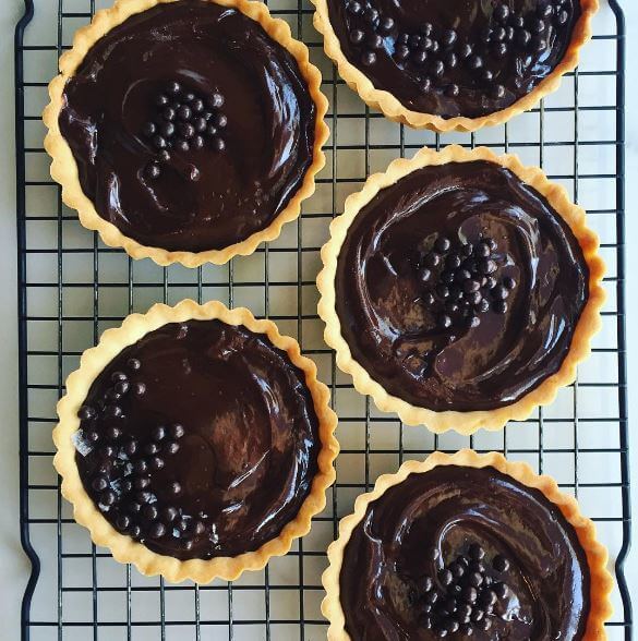 Dark chocolate ganache tarts with Maldon sea salt and chocolate crispies from Baking Bandits. Image: @bakingbandits Dark chocolate ganache tarts with Maldon sea salt and chocolate crispies from Baking Bandits. Image: @bakingbandits