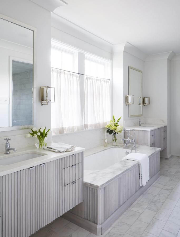 This fluted oak cabinetry and Alabama white marble take this bathroom to the next level.