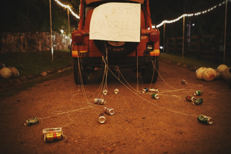 Josef's vintage Jeep served as the laid-back couple's coach, whisking them away from the reception with a simple poster and a gaggle of cans announcing their love. Josef's vintage Jeep served as the laid-back couple's coach, whisking them away from the reception with a simple poster and a gaggle of cans announcing their love.