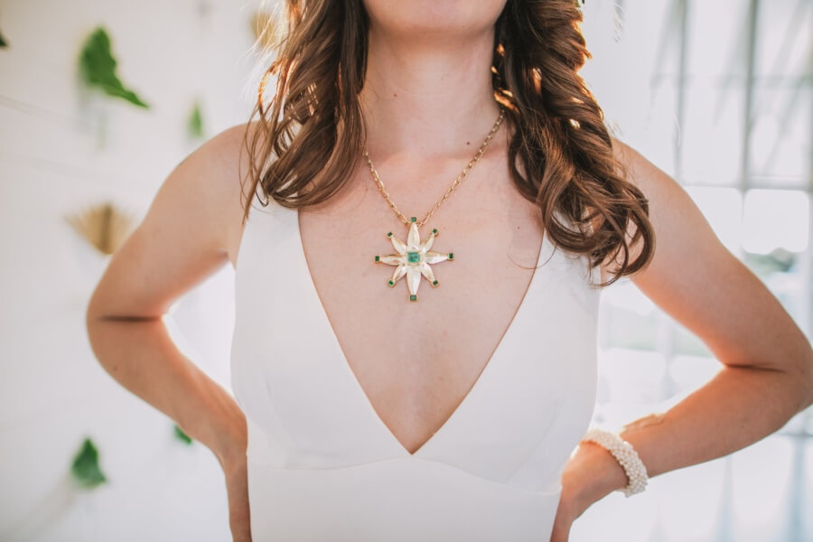 "My wedding pendant was definitely the most ambitious project I've taken on," says Mandy, who has been studying jewelry fabrication under a mentor in Austin. "I decided to make a compass rose with emeralds on each point of the star. My family sent along some of my grandmother's gold jewelry that I was able to melt down to make the pendant. It was so special to have her with us on the day. Even though she isn't alive anymore she is a guiding force in my life." The pendant necklace served as her "Something old" and "something new."