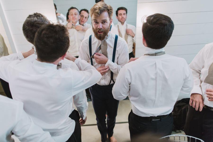 Matthew and his groomsmen tackle their bow ties.