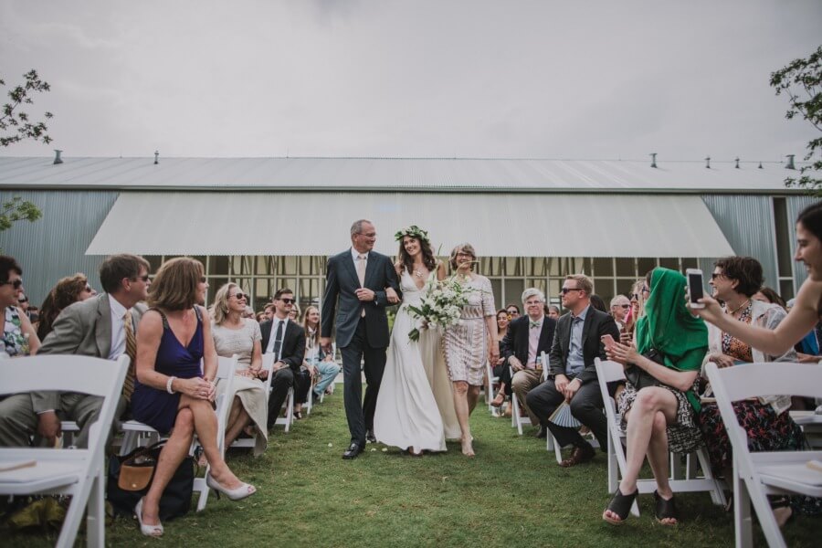 Mandy's mother and father walk her down the aisle.