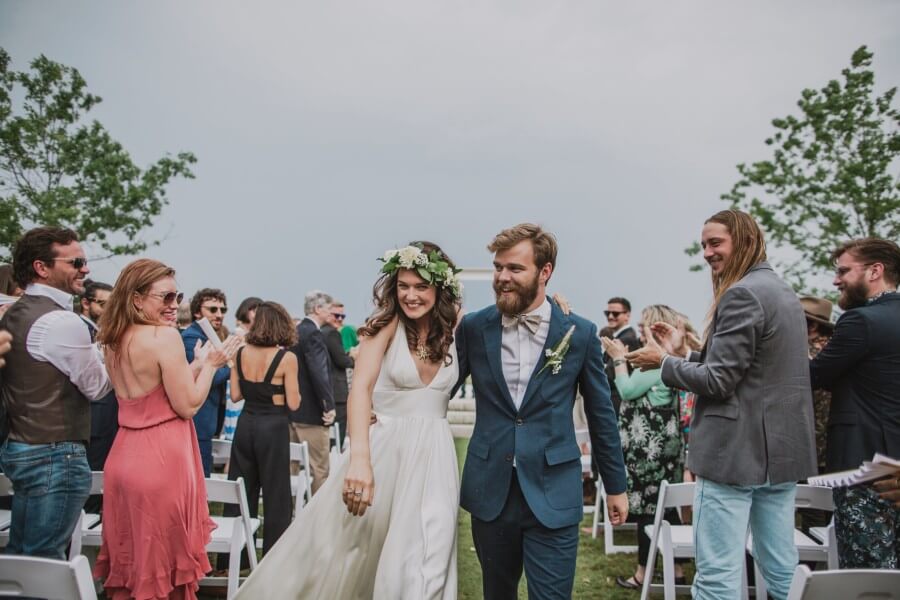 The happy couple make their exit among a crowd of smiles and applause.
