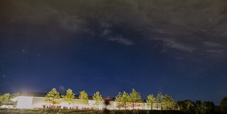 A view of the Prospect House at dusk under and expansive starry sky
