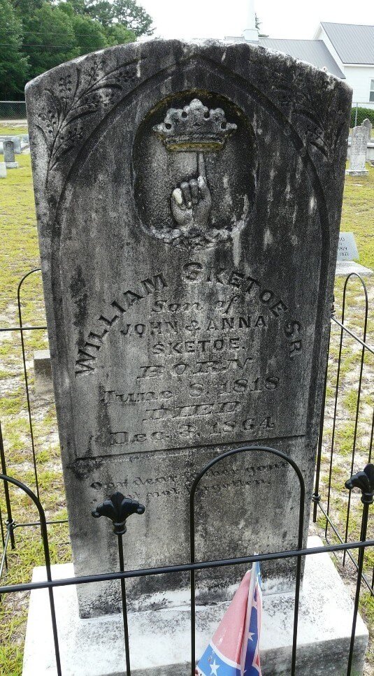 gravestone surrounded by a low fence