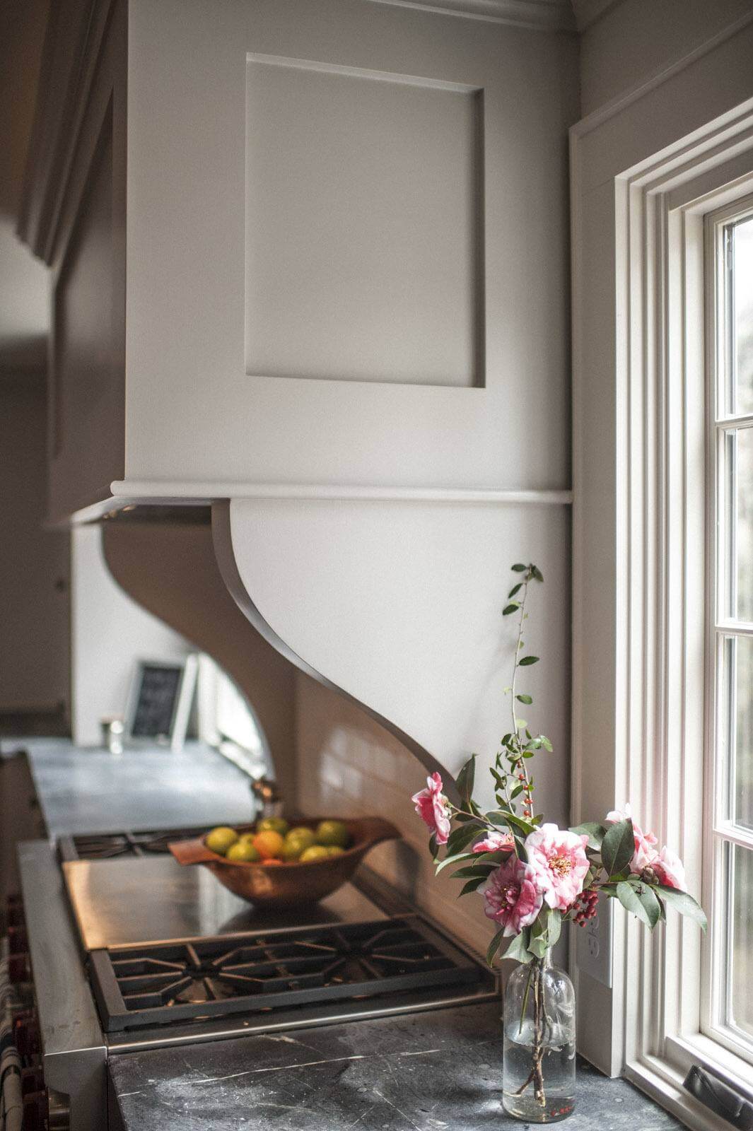 Beautiful countertops, quality range, subway tiles, natural light and a beautiful impromptu floral arrangement make for a Vermeer-esque vignette. Image: T. Scott Carlisle of Christopher Architecture and Interiors
