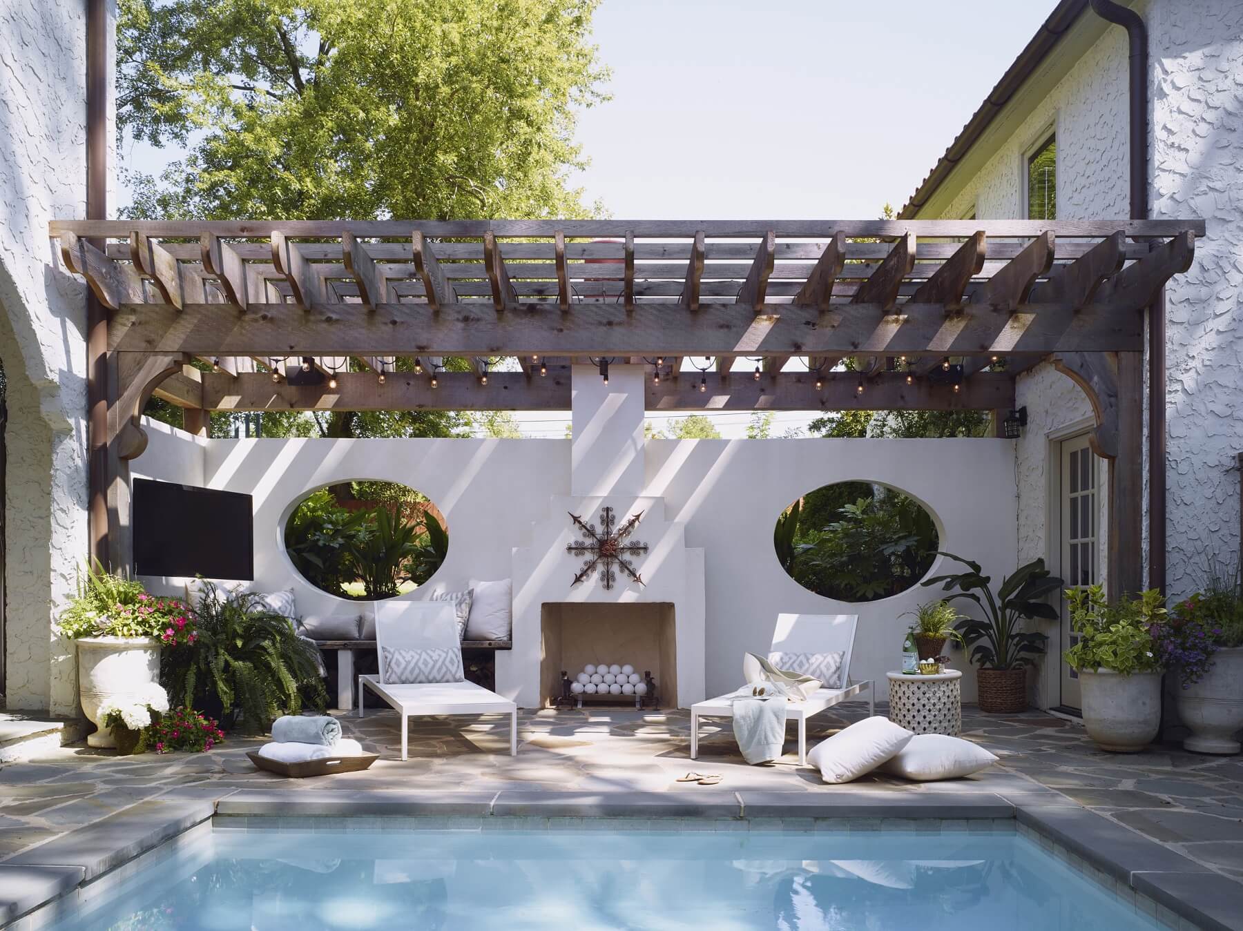This poolside haven, complete with TV and fireplace, is the perfect spot to unwind with friends. Image: Chris Luker