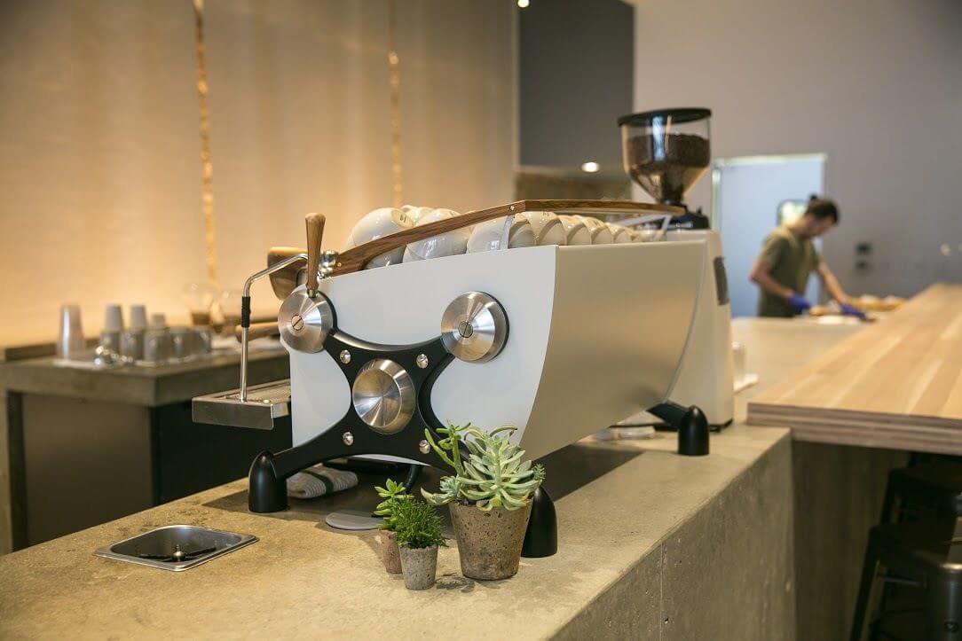 A sharp-looking espresso machine anchors the coffee station.