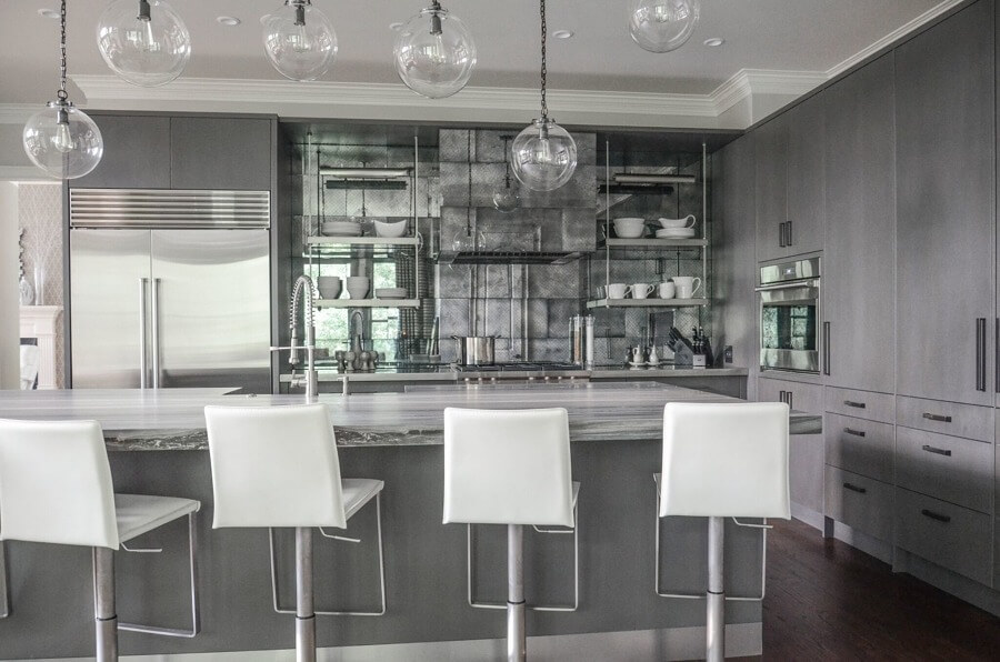 Interior designer Marty Mason chose these white barstools (which can be wiped down easily after spills) as a mod, lightweight addition to the kitchen.