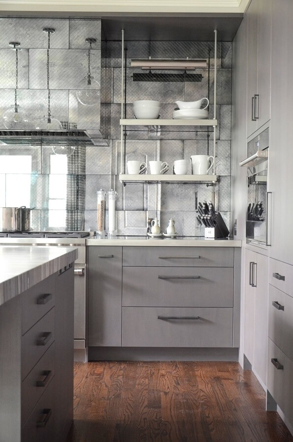 Floating stainless steel shelves are actually attached through the walls, but give the appearance of being supported by stylish metal bars.