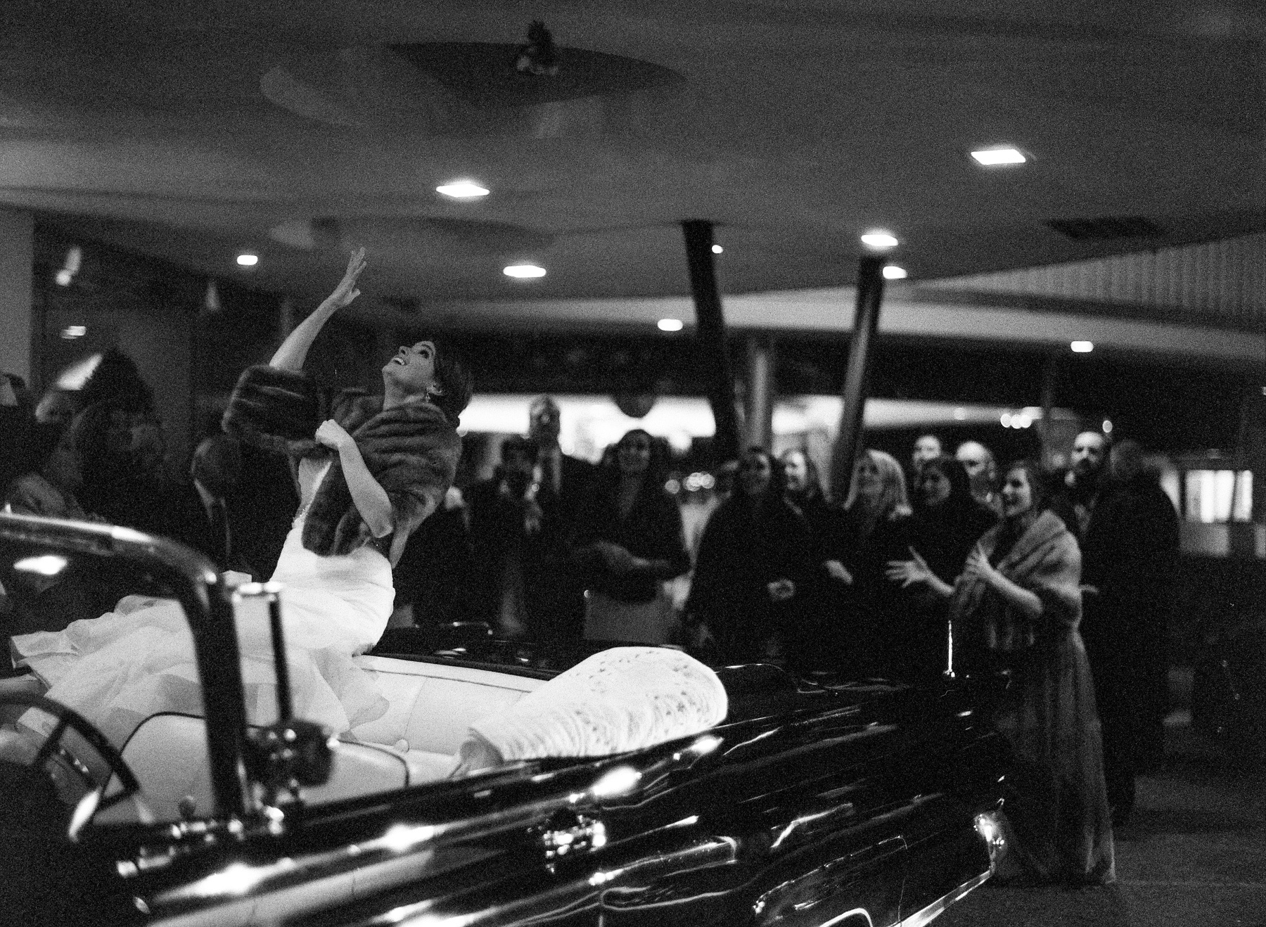 “Our getaway car, a vintage 1959 Lincoln Continental convertible, belongs to my step-dad,” Amy says. “Despite the cold, we were able to ride off with the top down and I tossed by bouquet from the top of the backseat.” “Our getaway car, a vintage 1959 Lincoln Continental convertible, belongs to my step-dad,” Amy says. “Despite the cold, we were able to ride off with the top down and I tossed by bouquet from the top of the backseat.”