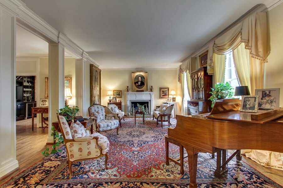 The formal living room features floor-to-ceiling windows, which provide abundant natural light. The formal living room features floor-to-ceiling windows, which provide abundant natural light.