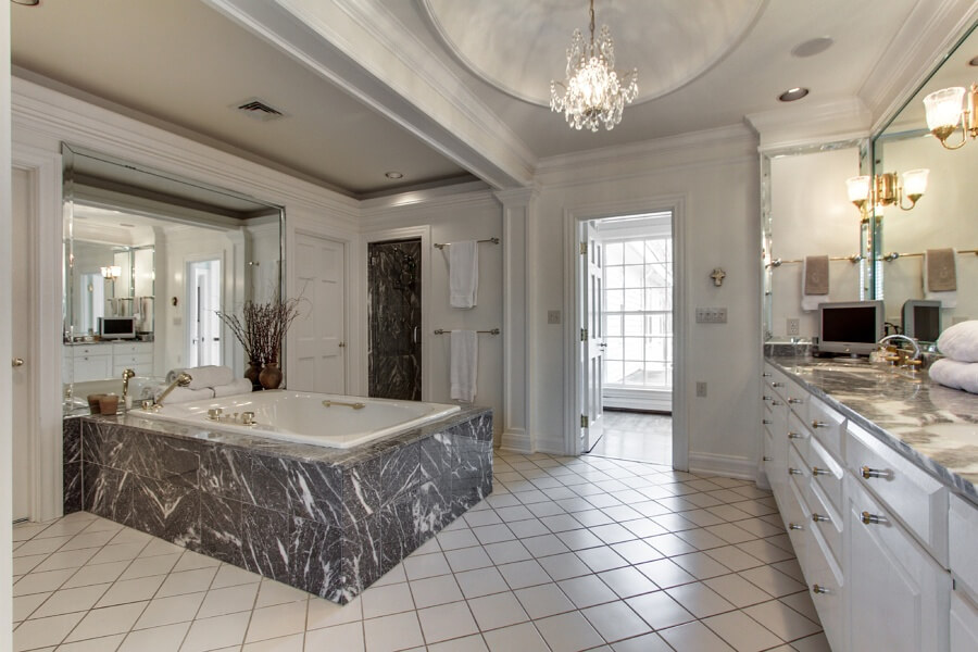 The master bath features tons of storage, tile flooring, a large whirlpool tub and his-and-her sinks. The master bath features tons of storage, tile flooring, a large whirlpool tub and his-and-her sinks.