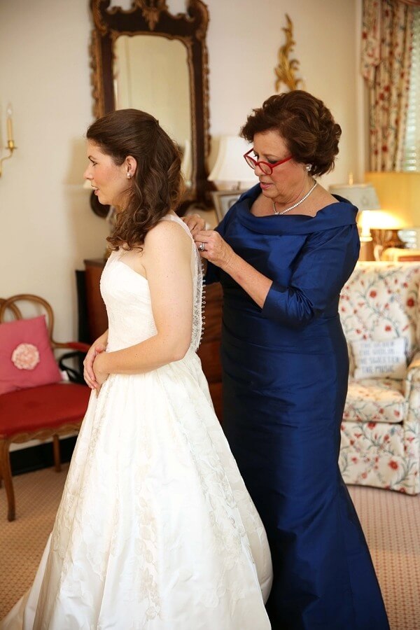 Don't estimate the importance of a good pair of readers as the bride's mother tackles buttoning up Florence's wedding dress.