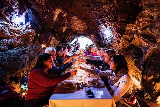 Mojo Active Adventures participants enjoy a gourmet meal in a cave in Iceland. Image: Molly Mathis