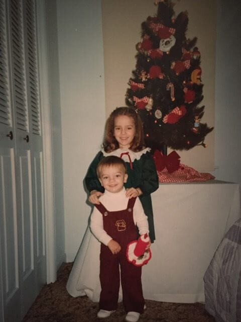 Jennifer Mims, 4, with her brother Adam, 2, in front of their great grandmother's Christmas tree in clothes her mother made for them