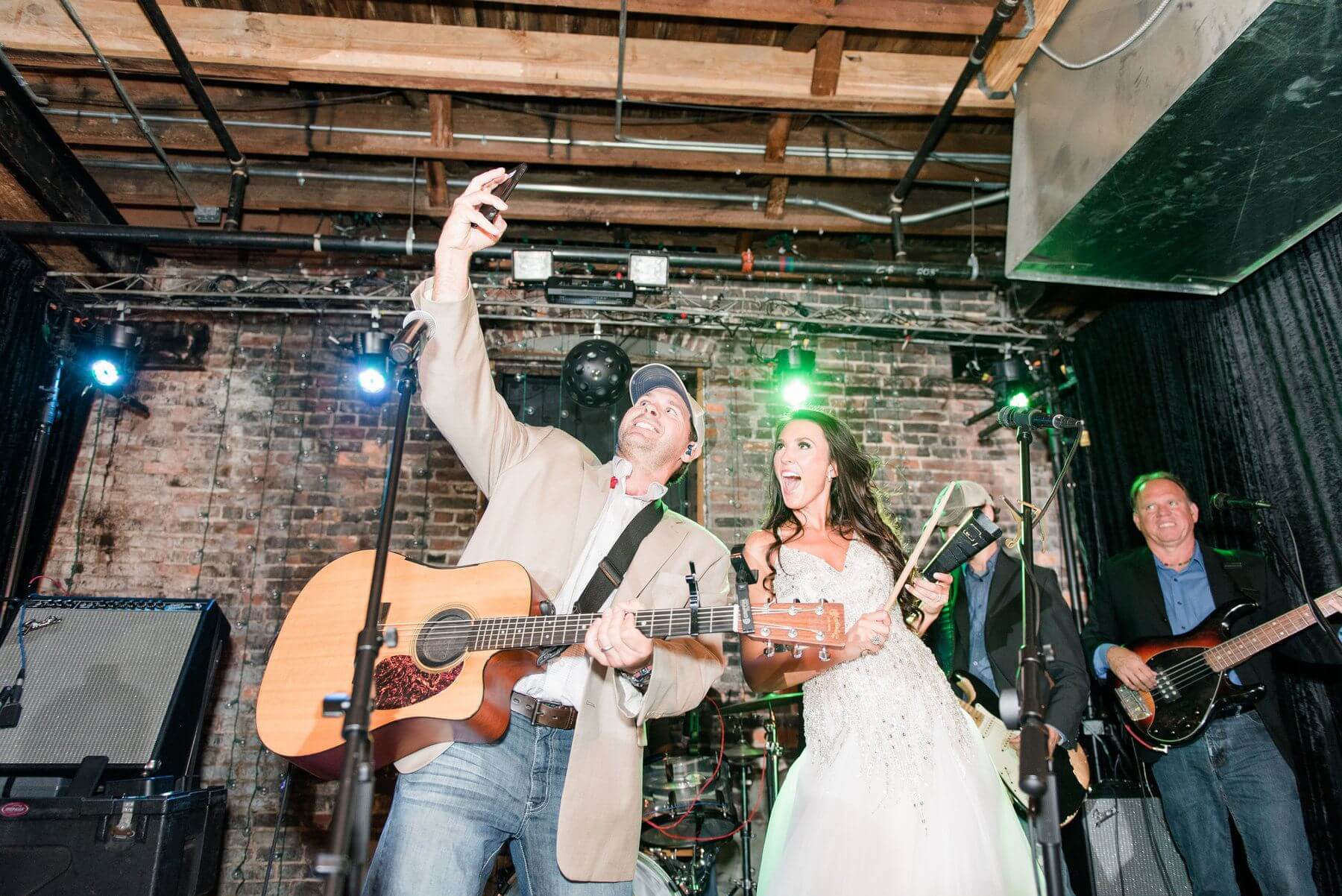 A fun reception was a top priority for this bride and groom! The newlyweds and their guests had such a good time dancing the night away with their band, Trotline, that the bride even hopped up on stage to play the cowbell!