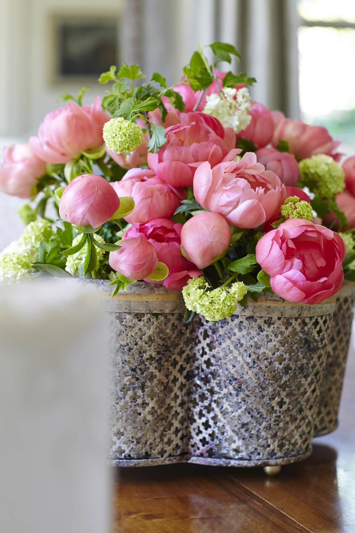 Beautiful pink peonies look effortlessly chic in this quatrefoil tole planter by Niermann Weeks. "It's great, because you can plant things in it or just set 4 small pots inside of it," says Iris.