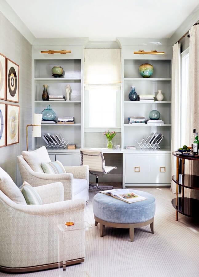 A sitting room/office can function as a place for the homeowner to work, or a casual spot for cocktails. The designer commissioned custom bookshelves and then specified a high-gloss lacquer finish on them to give the room a bit of shine and reflect light.