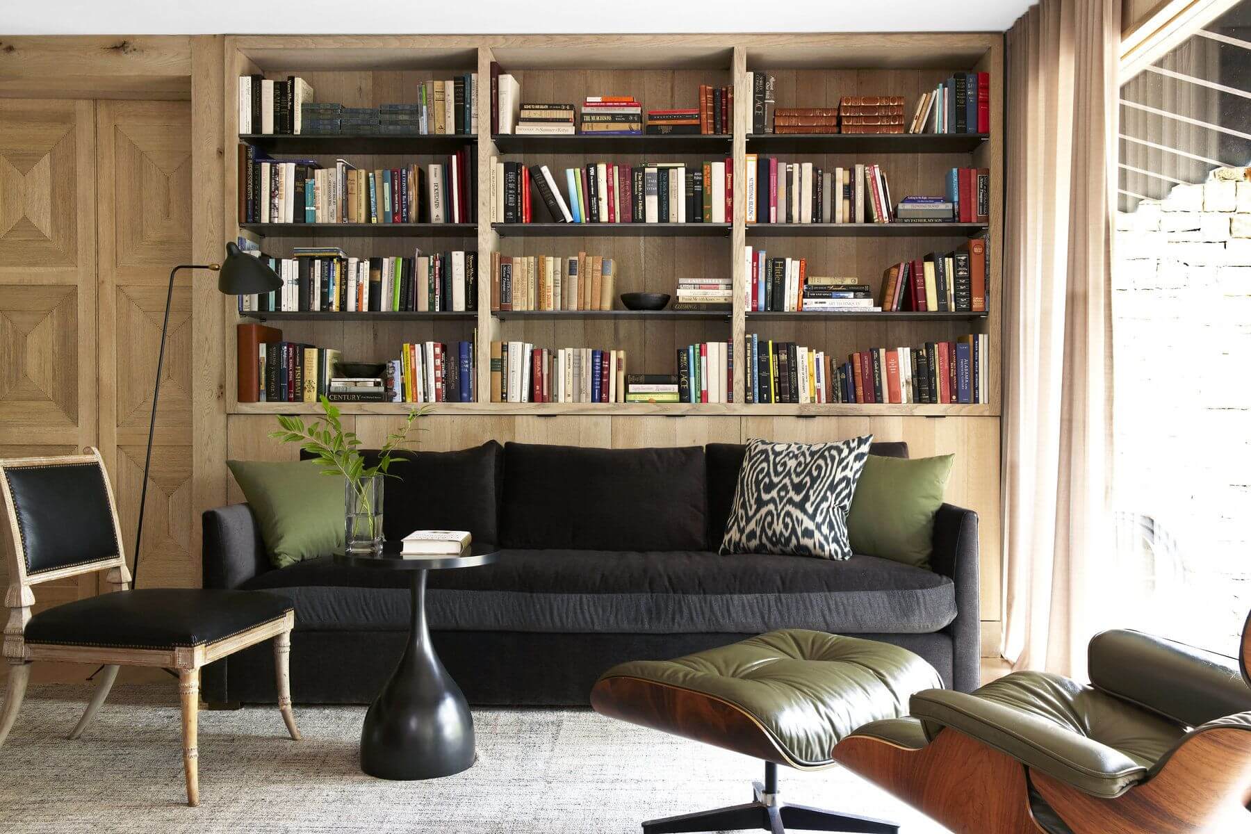 The master lounge features a Verellen sofa, Eames lounge chair and ottoman, antique regency chair, floor lamp by Serge Mouille and a kelim rug from Paige Albright Orientals. Image: Jean Allsopp
