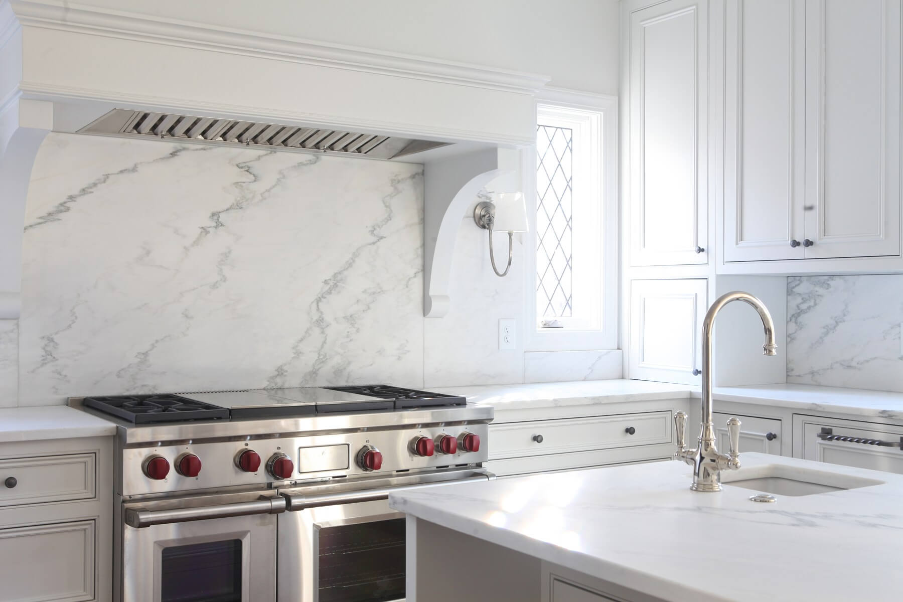 "This is my favorite prep sink, and I always add a disposal for chopping fruits and vegetables it helps with the clean up," says Cyndy. "This sink is also placed in a perfect location when cooking and not having to use the main cleanup sink." And an electric range on the old, skinny kitchen island is now replaced with a gleaming gas range fit for a king!