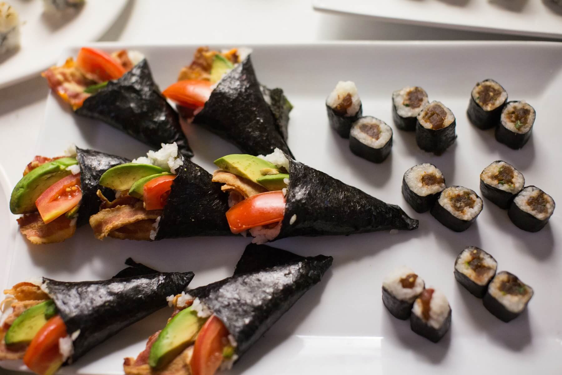 Guests dined buffet-style on the bride and groom’s favorite foods, including sushi, chicken biscuits, ravioli, New York strip sliders and shrimp.