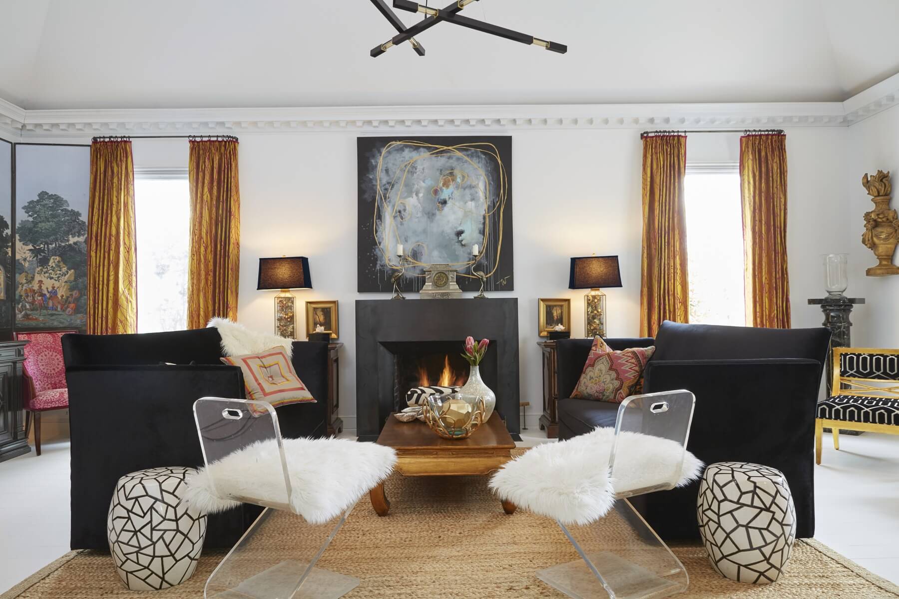 All of the mantels in the home were remodeled in sleek minimalist designs of burnished steel by Millsap Studios. Gorgeous black McAlpine sofas lend a stately modern presence and are complemented by the mid-century modern ghost chairs and plush sheepskin cushions. All of the mantels in the home were remodeled in sleek minimalist designs of burnished steel by Millsap Studios. Gorgeous black McAlpine sofas lend a stately modern presence and are complemented by the mid-century modern ghost chairs and plush sheepskin cushions.