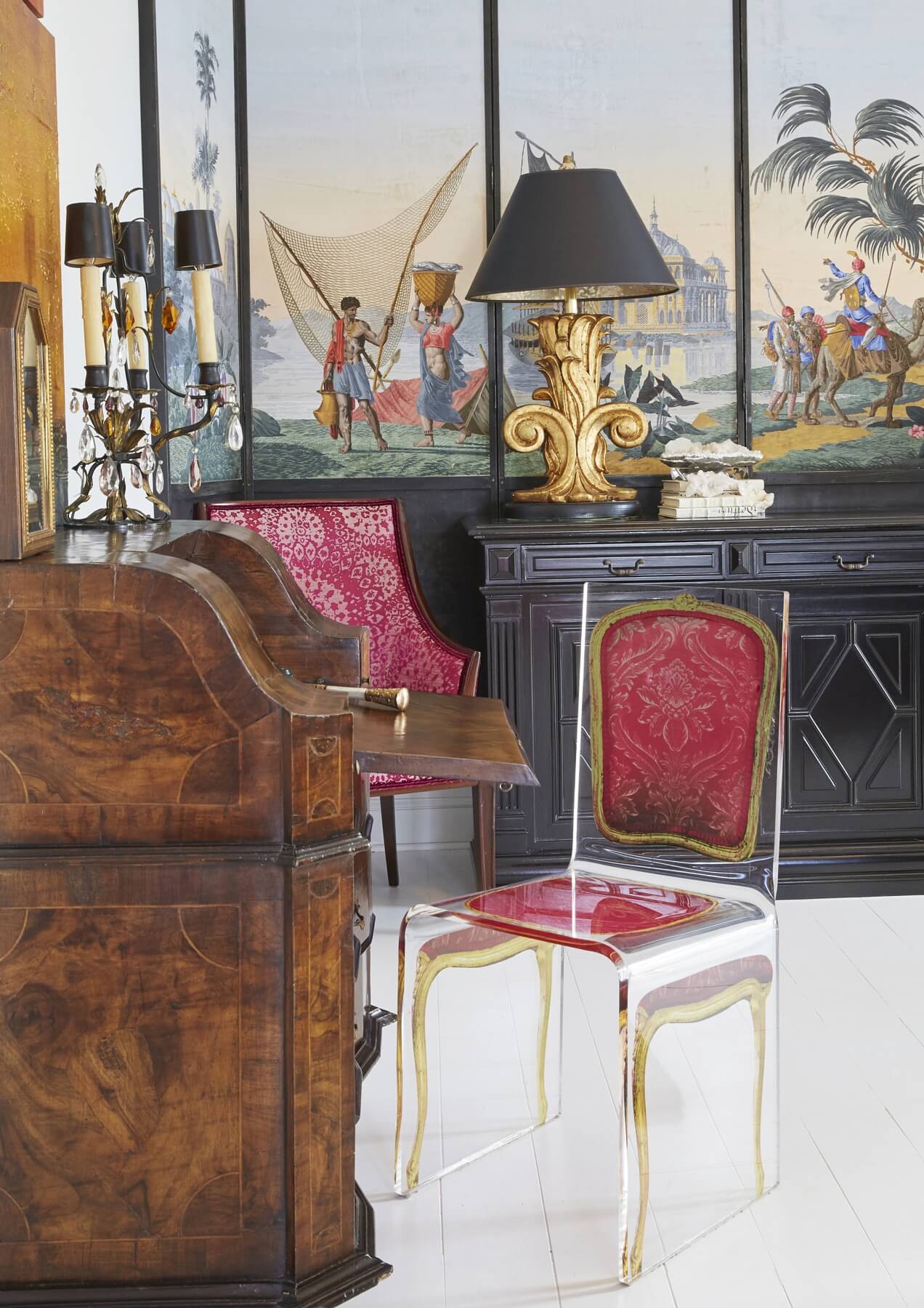 Em found this ghost chair with the image of a pink-upholstered French chair on 1st dibs, and was so delighted with it that she had to have it. In the background, another longtime piece she's always treasured is a 12-foot long French sideboard cabinet, which was once stained brown wood that she updated with glossy black paint. Em found this ghost chair with the image of a pink-upholstered French chair on 1st dibs, and was so delighted with it that she had to have it. In the background, another longtime piece she's always treasured is a 12-foot long French sideboard cabinet, which was once stained brown wood that she updated with glossy black paint.