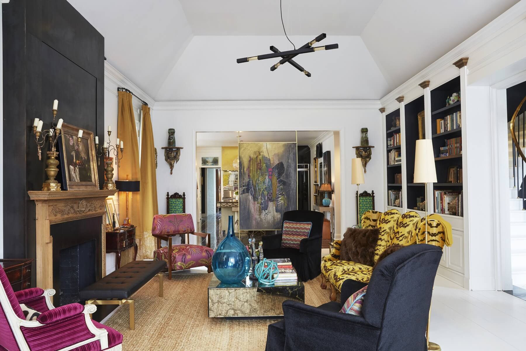 The only original piece remaining in this room is the original unfinished pine mantel with beautiful embellishments. The TV is hidden by an electronic lift in the large burnished steel fireplace. Bright pops of pink, turquoise and yellow-gold complement the black-and-white elements. The only original piece remaining in this room is the original unfinished pine mantel with beautiful embellishments. The TV is hidden by an electronic lift in the large burnished steel fireplace. Bright pops of pink, turquoise and yellow-gold complement the black-and-white elements.