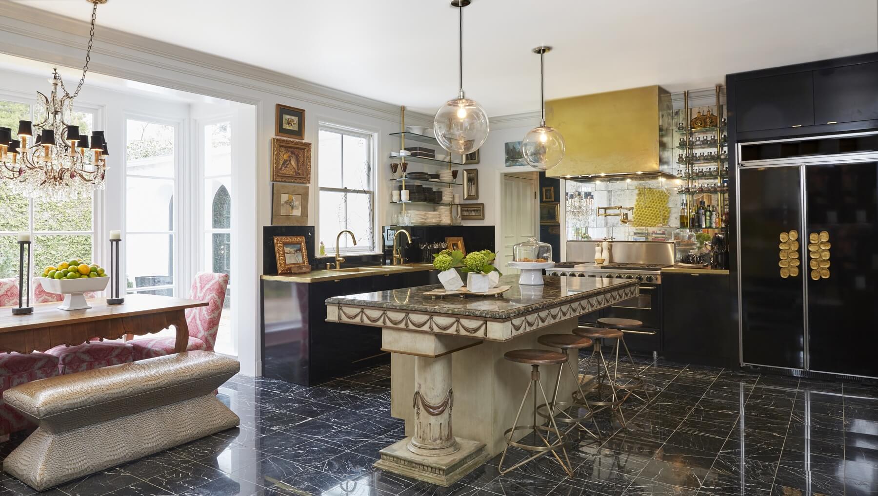 "The kitchen was a total re-do. I had our old dining room table raised to serve as the kitchen island with an added marble countertop and cabinet underneath. It was a glossy, minimal, contemporary look with unlacquered brass accents," says Em. "The whole thing is somewhere between contemporary and not contemporary, so that you have some sense of history. Antiques bring such warmth and life, your past — you can't just throw everything out that's good just to have the glossy, new and abstract." "The kitchen was a total re-do. I had our old dining room table raised to serve as the kitchen island with an added marble countertop and cabinet underneath. It was a glossy, minimal, contemporary look with unlacquered brass accents," says Em. "The whole thing is somewhere between contemporary and not contemporary, so that you have some sense of history. Antiques bring such warmth and life, your past — you can't just throw everything out that's good just to have the glossy, new and abstract."