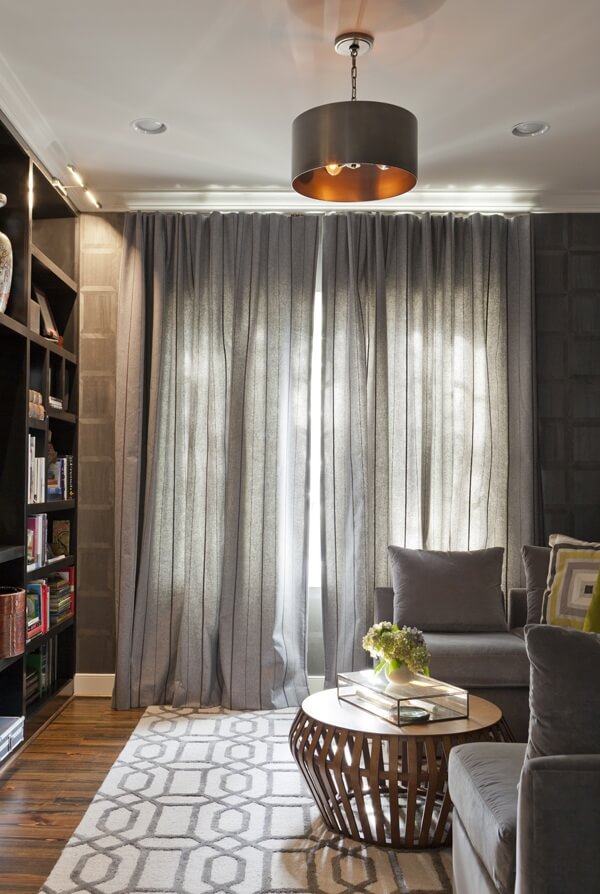 Geometrical elements in the rug pattern and coffee table intermingle with muted masculine grays and blacks for a calming library space. Image: Sarah Arrington of Spark & Arrow Geometrical elements in the rug pattern and coffee table intermingle with muted masculine grays and blacks for a calming library space. Image: Sarah Arrington of Spark & Arrow