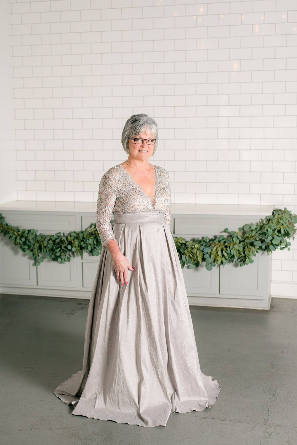 From The Clothes Tree by Deborah: Muted champagne quarter-length sleeve gown with stitched top, $770