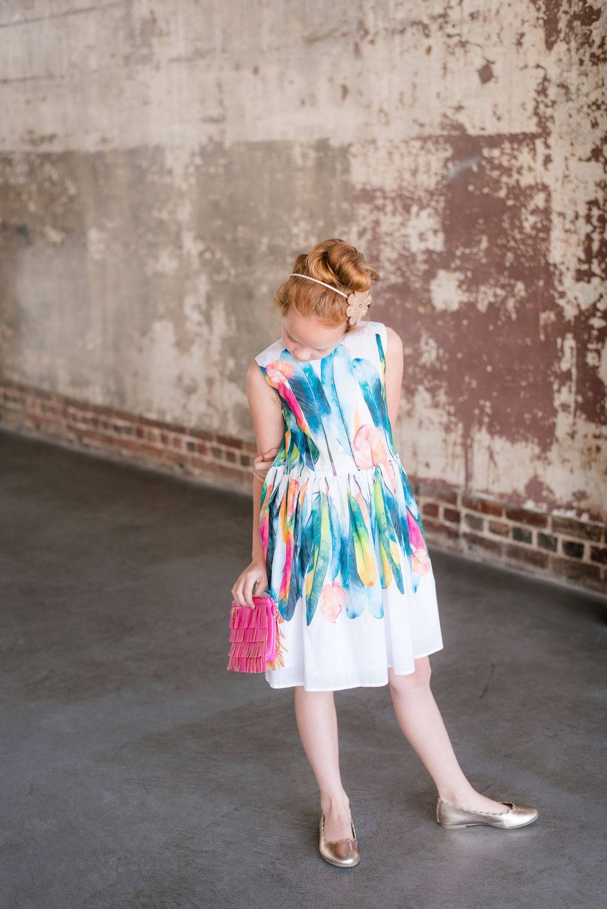 From GiGi's: Blue floral choker (comes with a solid blue choker and stud earrings,) $16; White dress with multicolor feather pattern, $98; Pink fringe wristlet purse, $32; Sparkly emoji headband, $20. 
