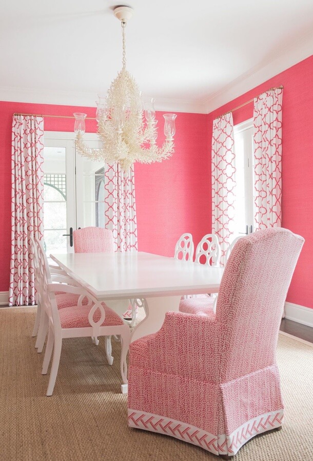 Thibaut curtain fabric--an embroidery in a traditional quatrefoil pattern--was the starting point for the dining room. The coral chandelier added the perfect coastal touch without being kitschy, adds the designers, while the pink grass cloth walls really pack a punch. “Because the grass cloth is broken up by a doorway on every wall, you get a little visual relief,” says Adrian. “It’s not overwhelming.” A white lacquered table also provides some glossy contrast. Thibaut curtain fabric--an embroidery in a traditional quatrefoil pattern--was the starting point for the dining room. The coral chandelier added the perfect coastal touch without being kitschy, adds the designers, while the pink grass cloth walls really pack a punch. “Because the grass cloth is broken up by a doorway on every wall, you get a little visual relief,” says Adrian. “It’s not overwhelming.” A white lacquered table also provides some glossy contrast.