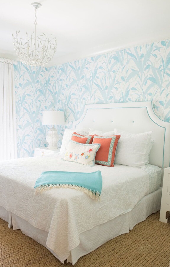 The designers chose a vintage-inspired Meg Braff (meggraffdesigns.com) wallpaper to set the tone for this guest bedroom. Other elements are simple to coordinate: white curtains and a white headboard, both trimmed in turquoise, with white lamps on white lacquered nightstands. The designers chose a vintage-inspired Meg Braff (meggraffdesigns.com) wallpaper to set the tone for this guest bedroom. Other elements are simple to coordinate: white curtains and a white headboard, both trimmed in turquoise, with white lamps on white lacquered nightstands.