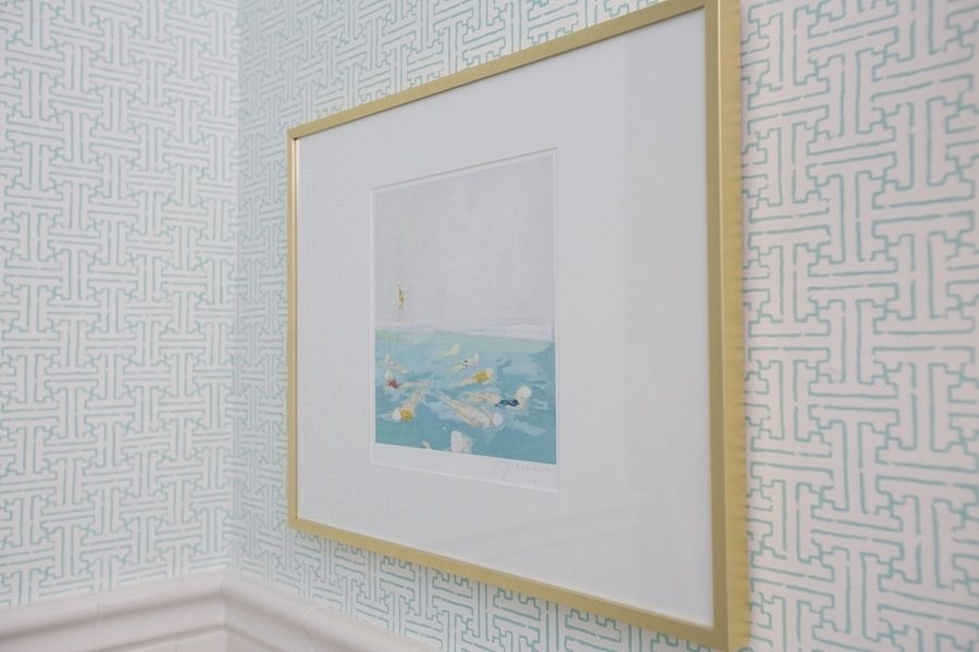 In this bathroom, Thibaut’s Taza wallpaper in aqua complements the artwork by Lisa Golightly.
