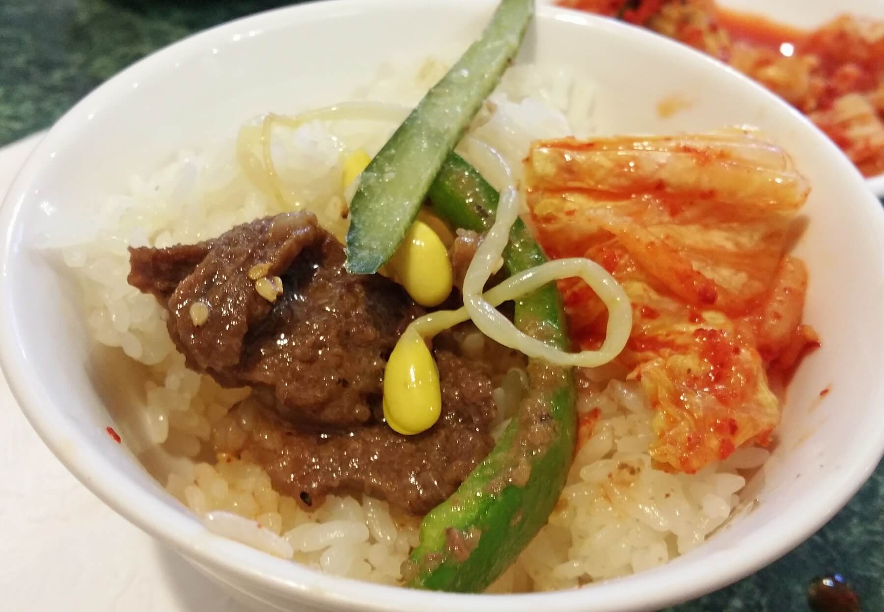 Tailor each bite to your liking with savory beef and peppers, crunchy and sweet cucumber, mung bean and spicy kimchi on rice — Yum! Tailor each bite to your liking with savory beef and peppers, crunchy and sweet cucumber, mung bean and spicy kimchi on rice — Yum!