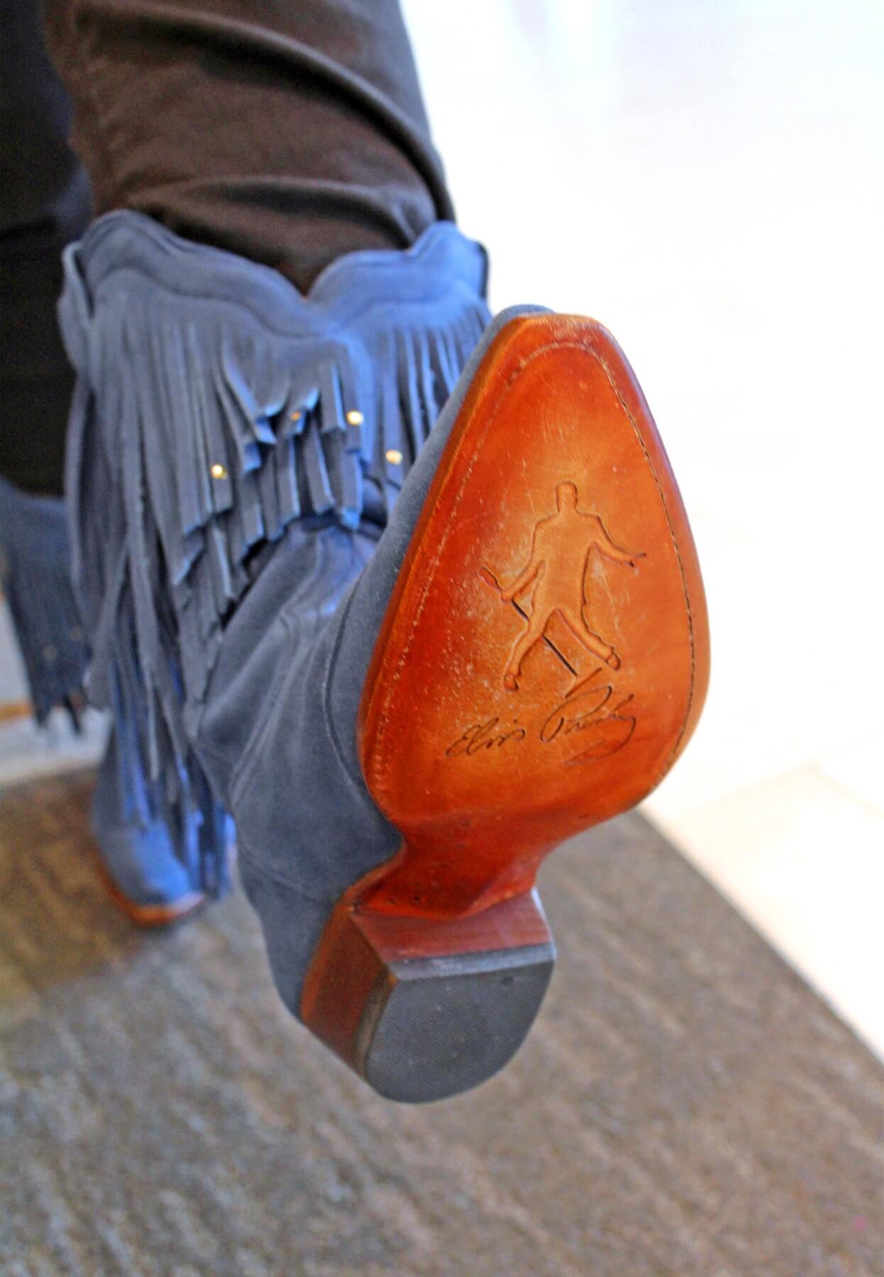 The sole of Fara Sclafani’s blue suede boot features Elvis’ silhouette and signature.