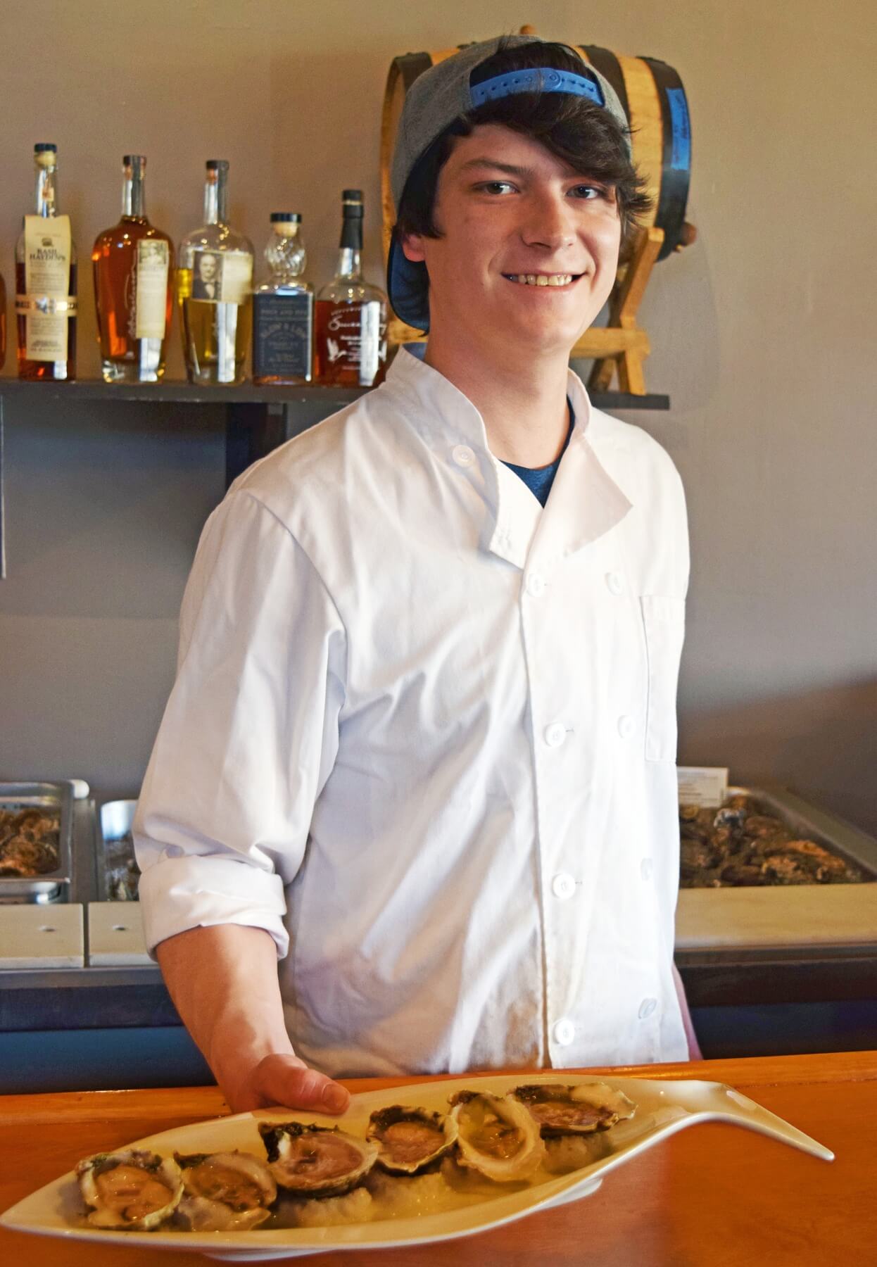 Justin Brooks shucks oysters to order. Justin Brooks shucks oysters to order.