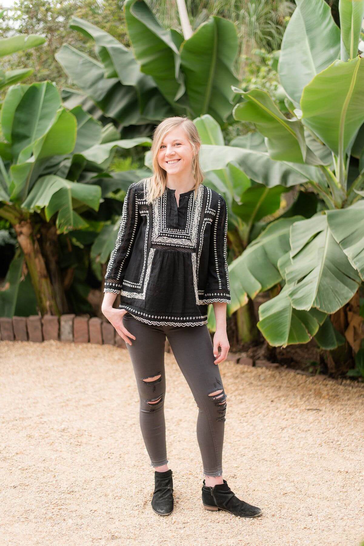 From Elle Birmingham: Embroidered, black quarter-length sleeve top, $349; Low-rise, black denim jeans, $199.