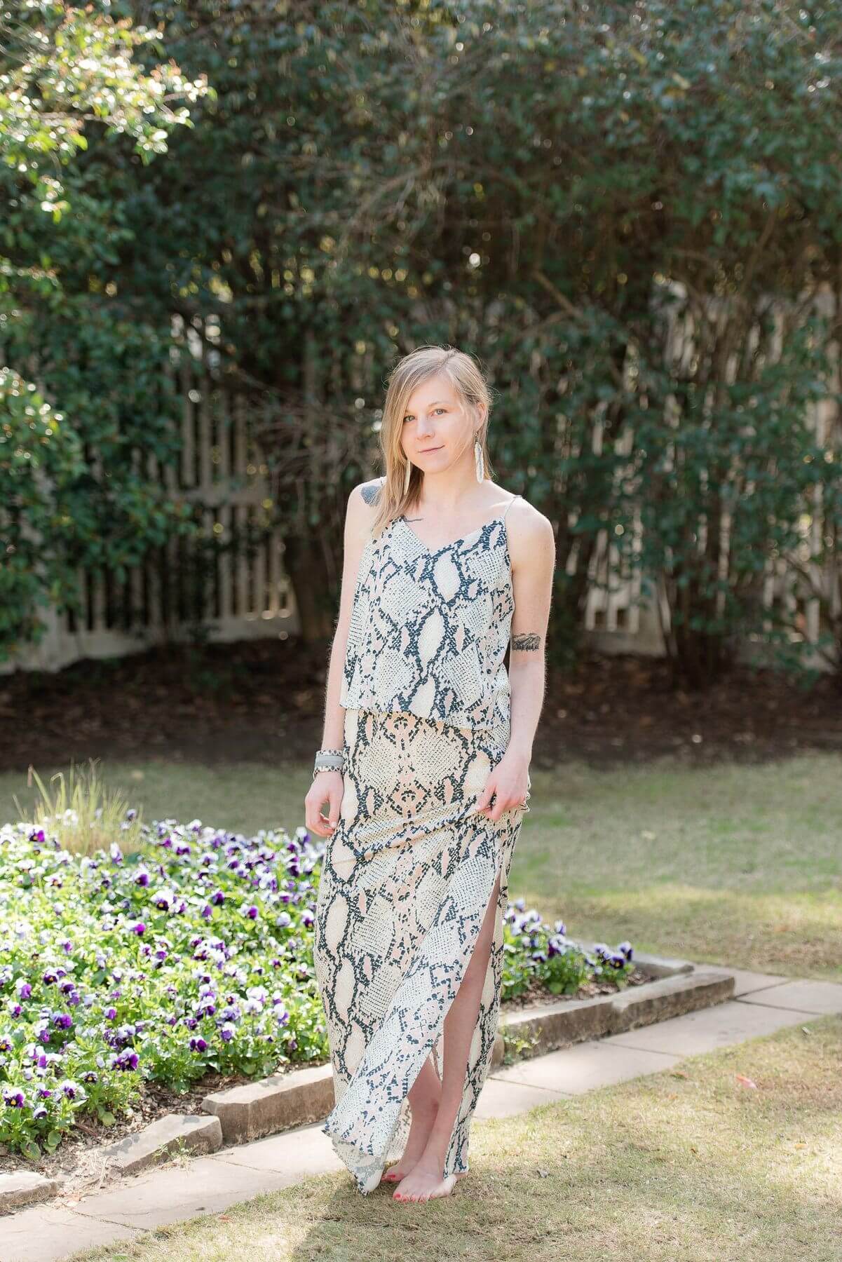 From Elle Birmingham: Snakeskin print maxi dress, $244; White, feather earrings, $192, Cowhide cuff, $145.
