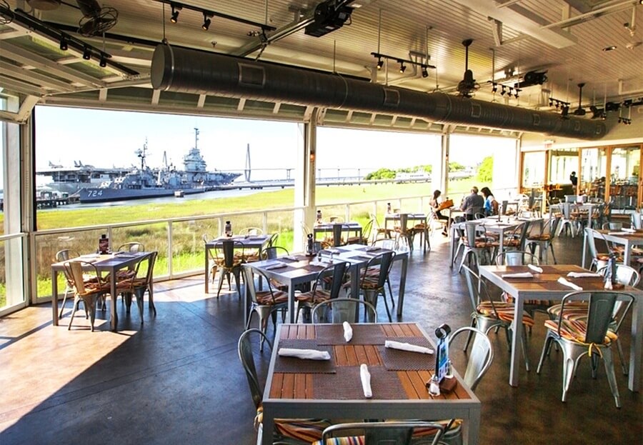  Sustainable seafood is served with a dose of war history at the Charleston Harbor Fish House, where guests overlook the USS Yorktown aircraft carrier, as well as other vessels (all available to tour). Image: Charleston Harbor Fish House