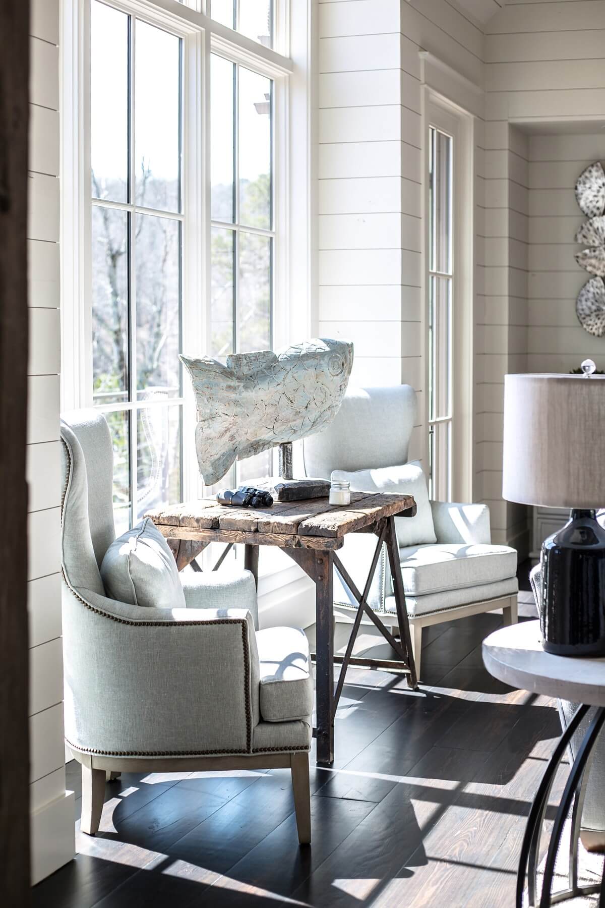 On buying trips to Atlanta, Morgan and Cindy found fabulous antique and vintage pieces, like this weathered table, which lends an element of texture and patina to the decor.