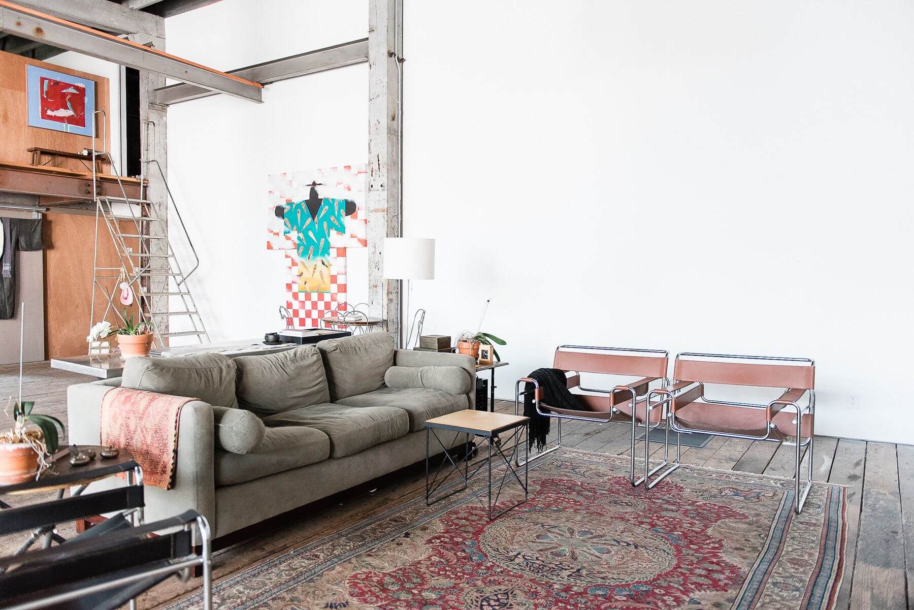 Two beautiful ox-blood red Marcel Breuer Wassily chairs anchor the "living room" ensemble. Two beautiful ox-blood red Marcel Breuer Wassily chairs anchor the "living room" ensemble.