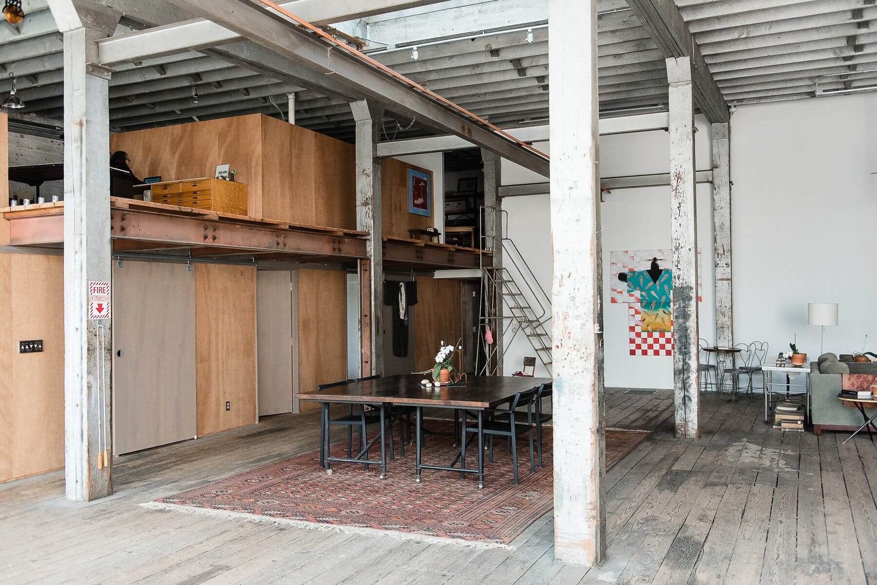 This view affords one a peek into Cheryl's upstairs office space on the light-filled mezzanine level. This view affords one a peek into Cheryl's upstairs office space on the light-filled mezzanine level.