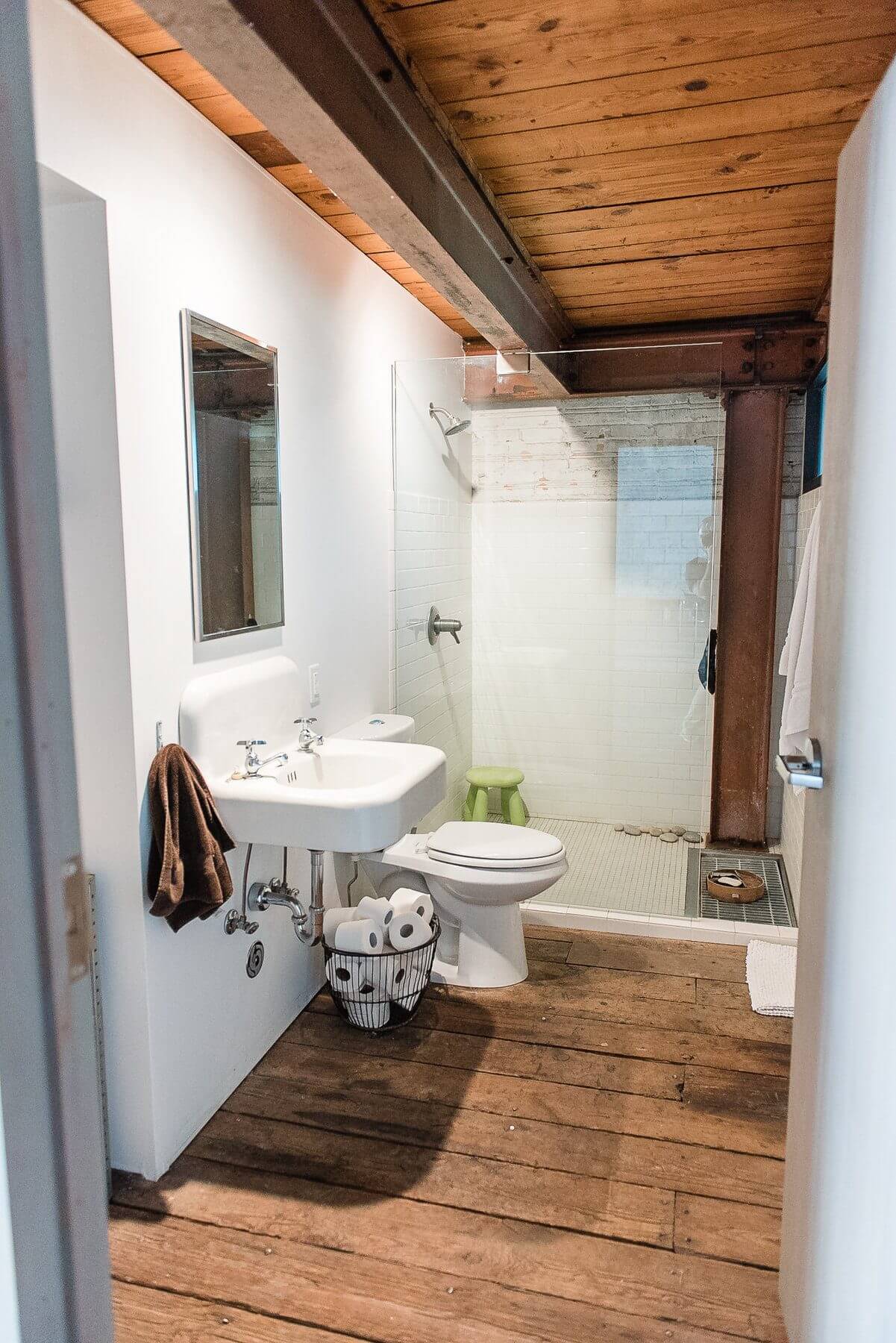 Warm wood and rustic steel beams mix with modern whites, minimal glass, subway tiles and a lime green accent piece for a guest bathroom we just adore! Warm wood and rustic steel beams mix with modern whites, minimal glass, subway tiles and a lime green accent piece for a guest bathroom we just adore!