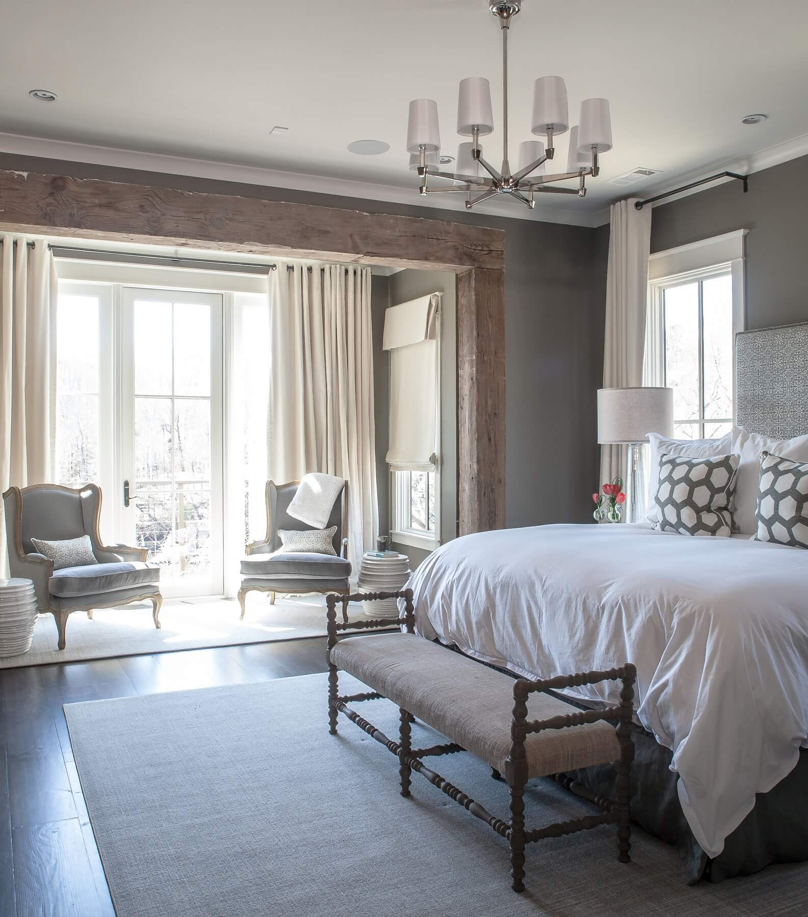 Reclaimed wood beams complement the sleek elegance of the bedroom decor.