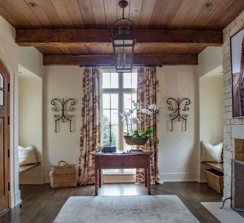 This cozy foyer with a fireplace and built-in bench seats is a warm and inviting room in its own right. 
