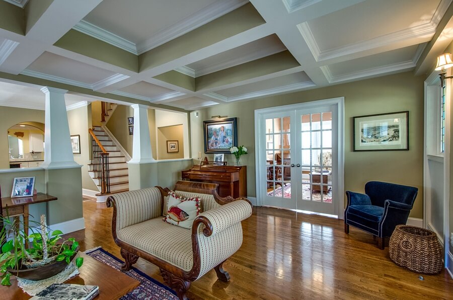 The library is located trough the French doors. And you can also see one of the home's two staircases leading to the second floor.