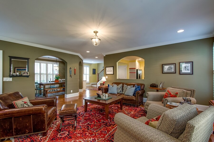 Looking back toward the kitchen from the family room, you can see the second staircase leading to the second floor as well as the pass-through between the family room and kitchen, which enhances the openness this house exudes.
